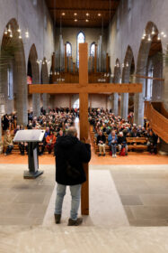 a man standing in front of a large crowd of people